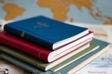 A stack of passports and various international travel documents, signifying global readiness.